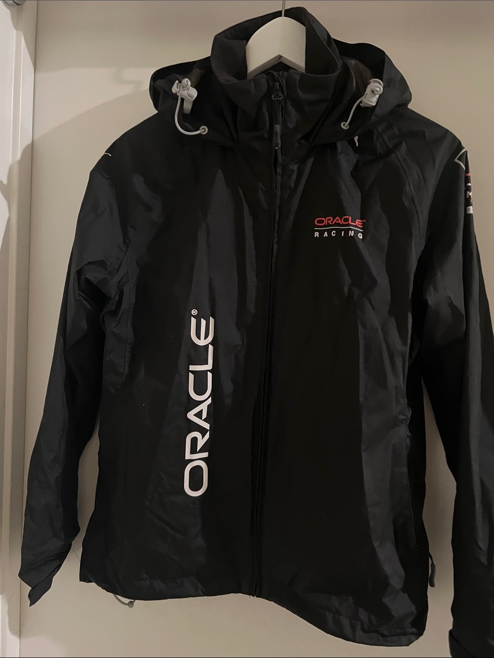 Puma Black Hooded Racing Jacket with White Oracle Logos and Red Accent